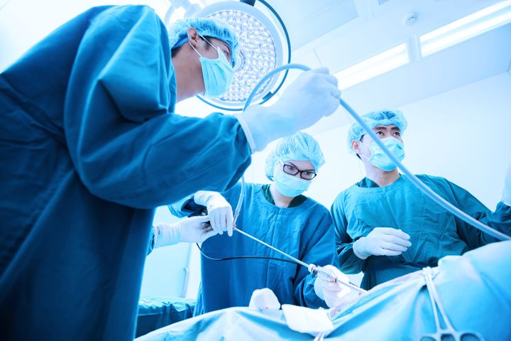 An interventional radiology nurse assists with a procedure.