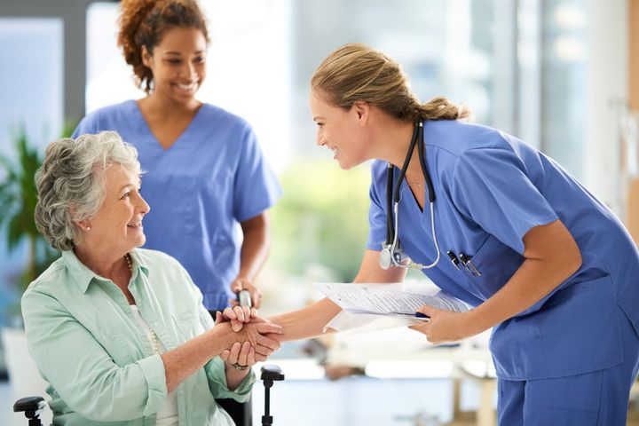 Charge nurse interacting with patient