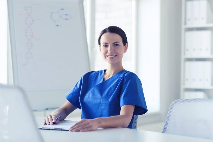 A nursing student pursuing an AAS nursing degree poses while studying.