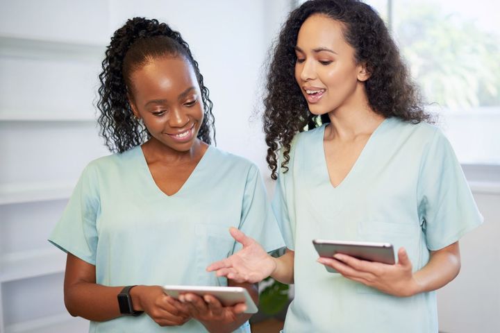 Two nurses using the CMS IOM.
