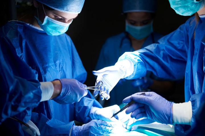 A surgical team operates on a patient.