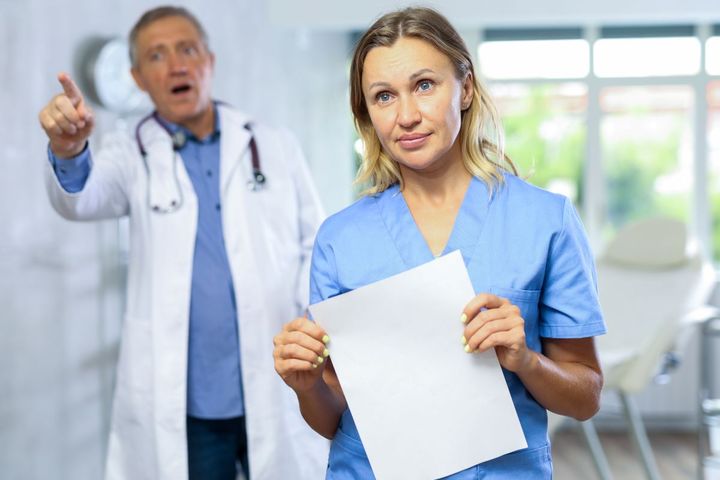 A nurse and doctor try to de-escalate a tense moment with a patient.