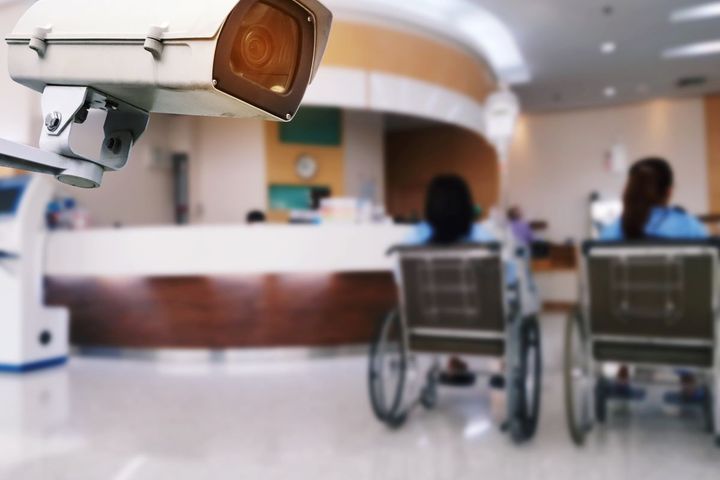 A surveillance camera in the hallway of a hospital.