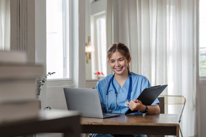 A nurse manager goes over resumes, incorporating exclusion screening as part of the process.