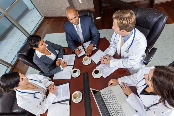 Hospital executives meet for a breakfast meeting.