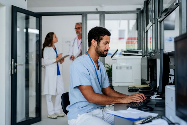 A nurse checks computer files.