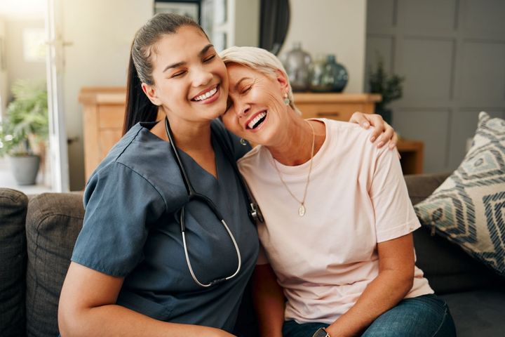 A home health nurse shares a tender moment with one of her patients.