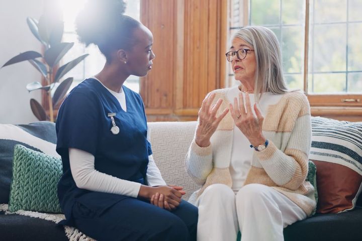 A nurse listens to one of her patients explain an event.