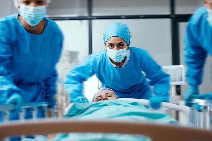 A team of healthcare professionals responds to a medical surge at a hospital.