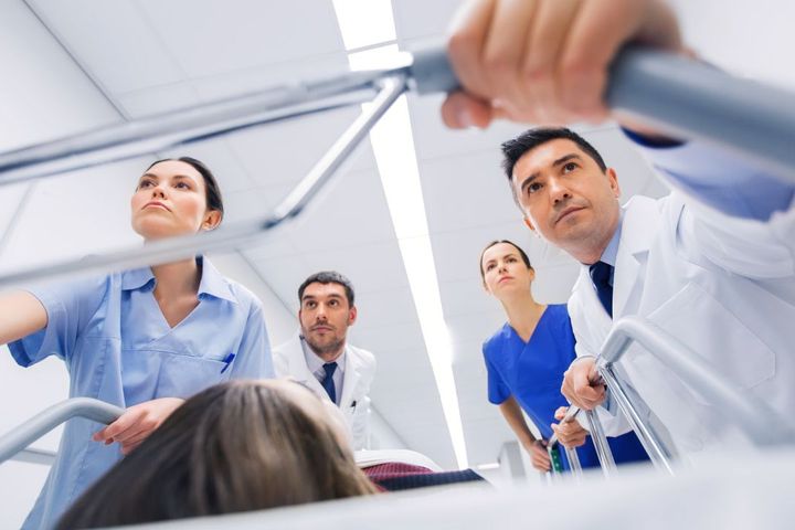 A team of nurses and physicians attends to a patient in a medical emergency.