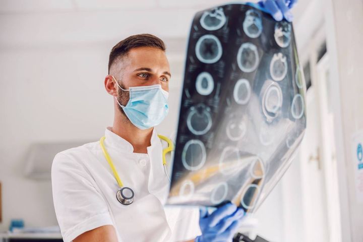A neurology nurse practitioner analyzes brain imaging.