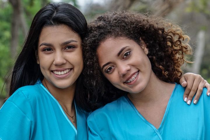 Two new grad RNs pose for the camera.