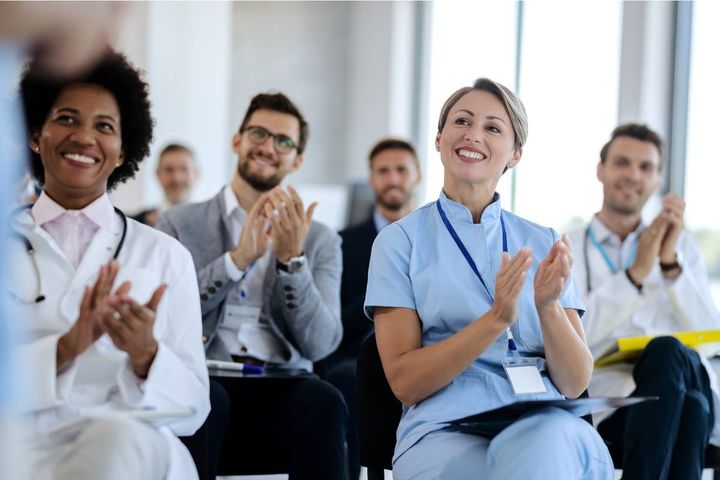 A group of healthcare professionals meet to discuss Nurses Week ideas to celebrate.