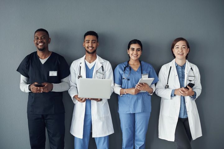 A group of nurses and physicians prepares to ask a candidate peer interview questions.