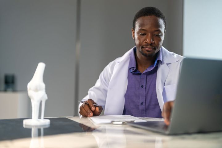 A physician reviews quality metrics.
