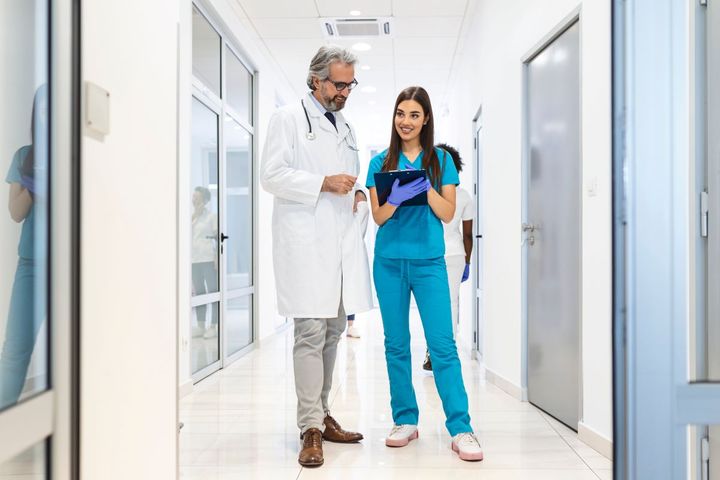 A nurse manager meets with a physician.