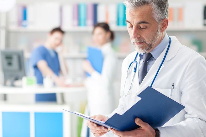 A physician looks at confidential patient information, mindful of Red Flags Rule protections.