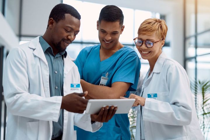 A team of medical professionals looks at a patient's data together.