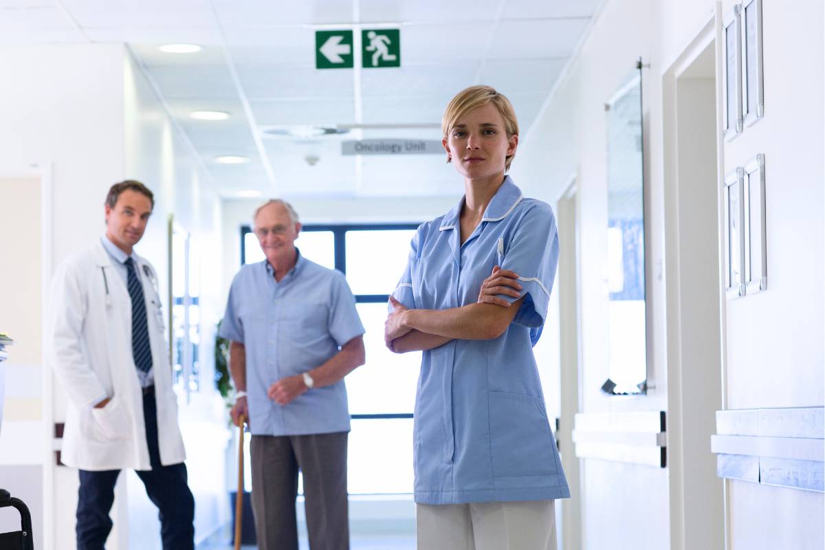 A nurse poses for a photo after demonstrating accountability in nursing with her supervisor.