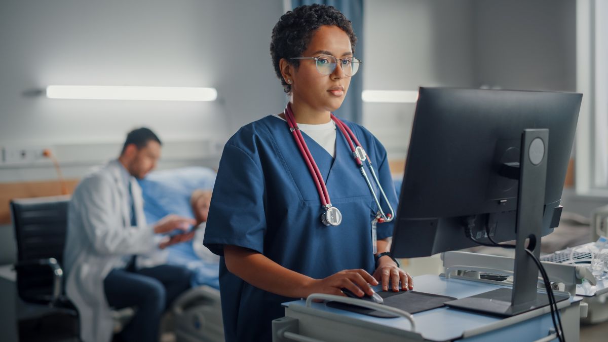 A nurse checks information recorded to the EHR by the facility's ambient AI system.