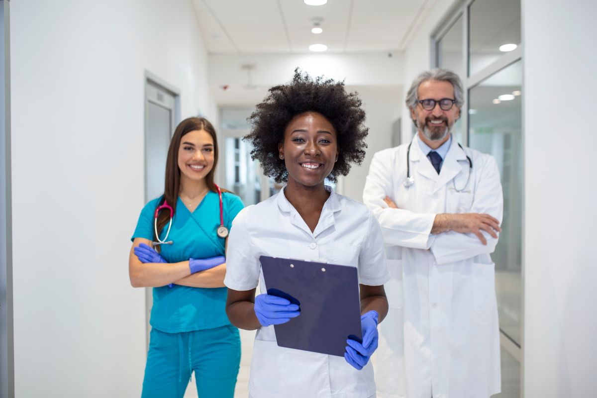 Members of a healthcare team in an Arkansas facility smile at the camera.