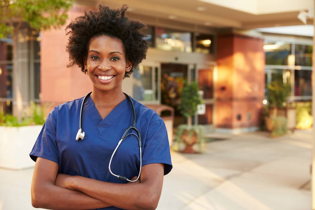 A nurse poses for a photo while explaining the impact of Black female nurses throughout history.