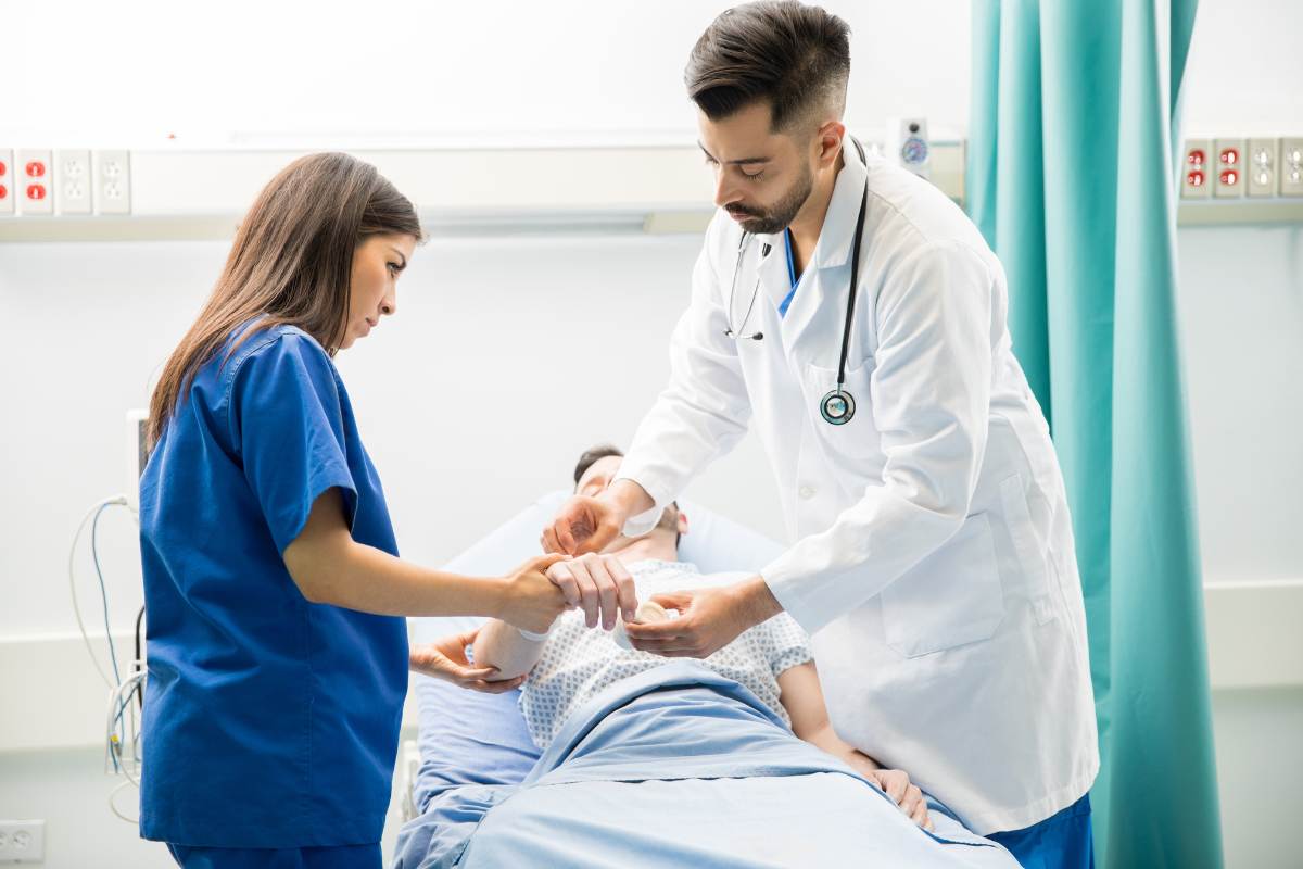 A burn unit nurse changes a bandage on a patient's arm.