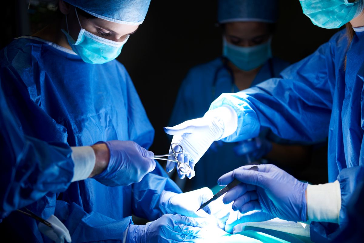 A surgical team operates on a patient.