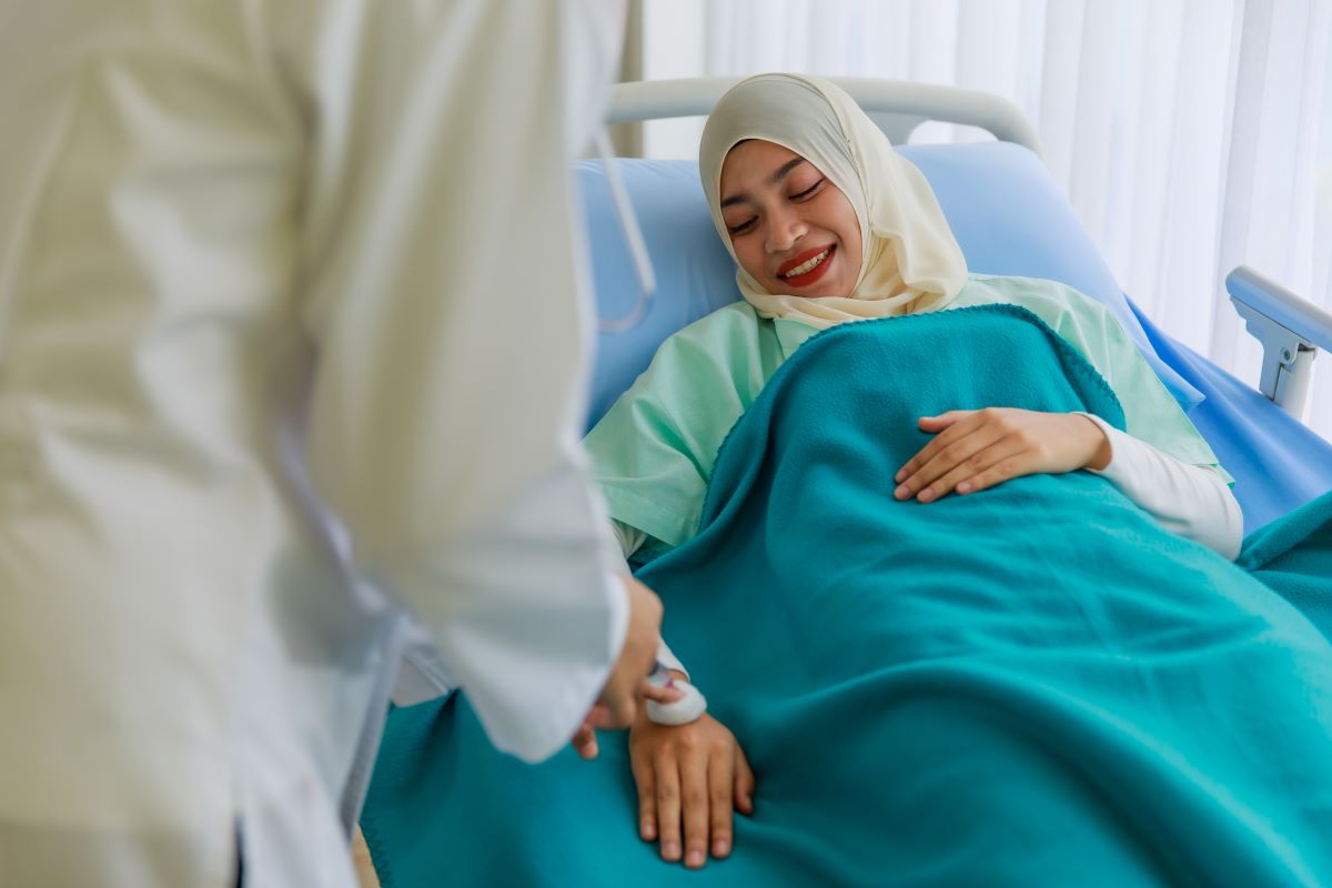 A nurse attending to a patient wearing a hijab, highlighting the importance of cultural competence in healthcare settings.