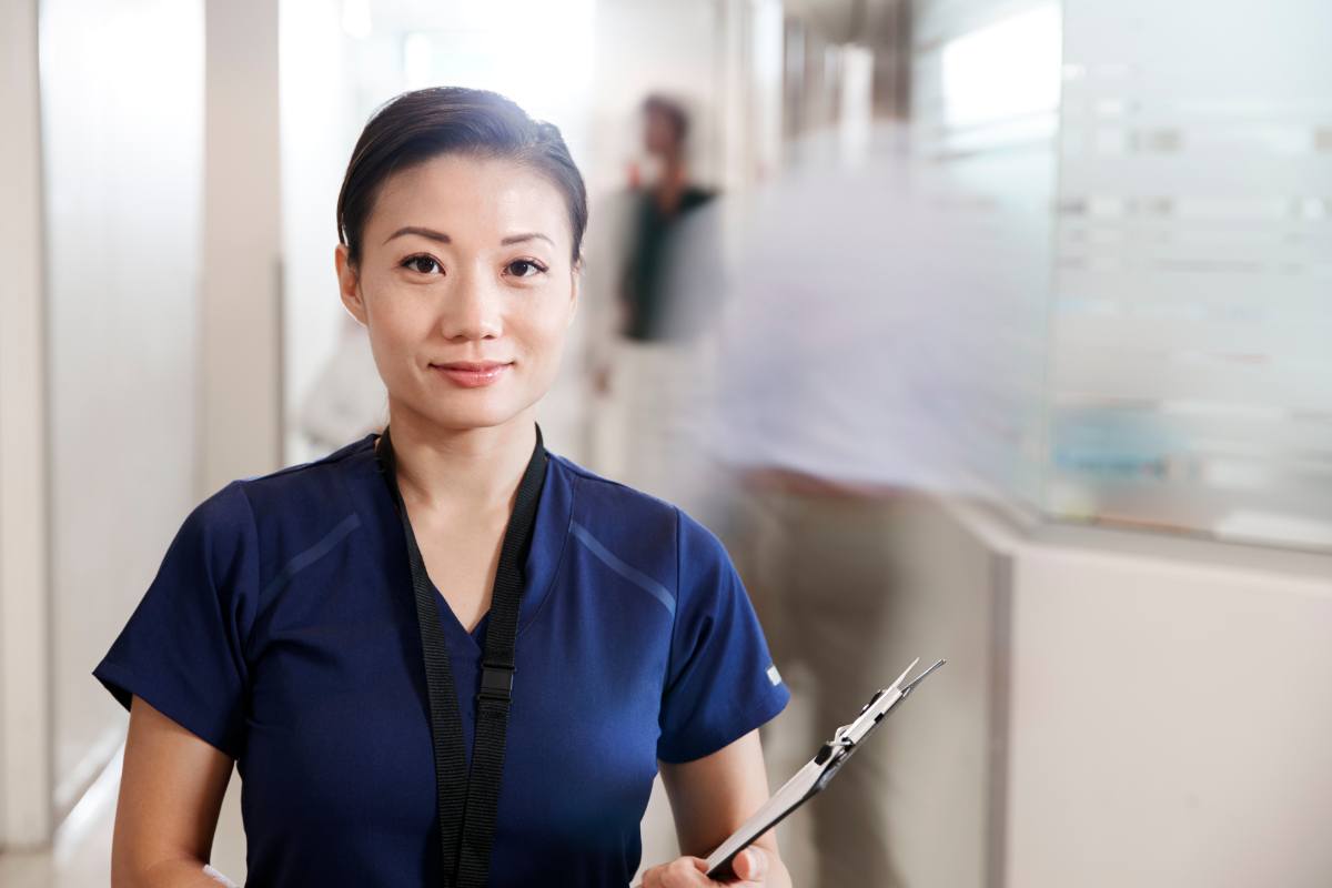 A nurse holds her dermatology nurse resume before an interview.