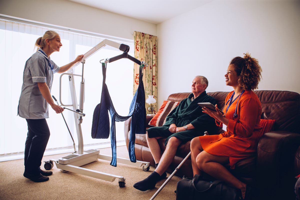 A nurse shows a patient how to use a piece of durable medical equipment for mobility.