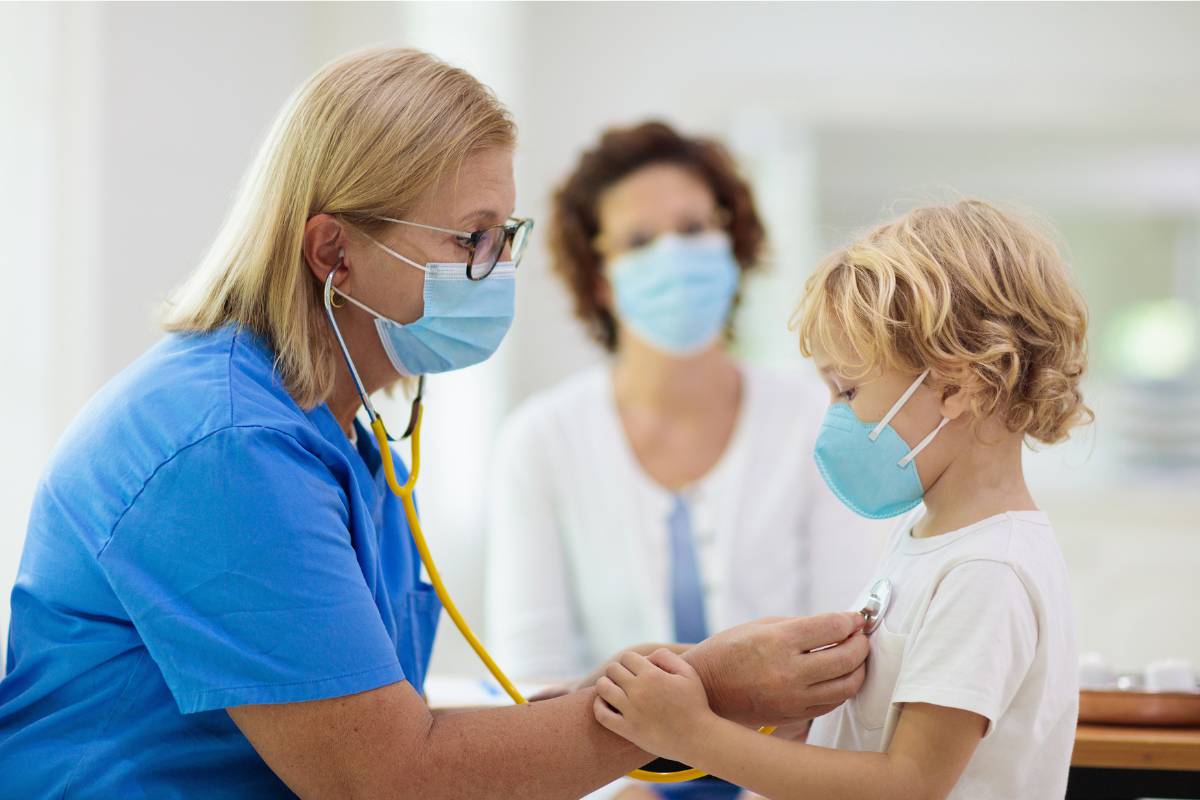 A nurse uses ENPC certification skills to assist a young patient in the emergency room.