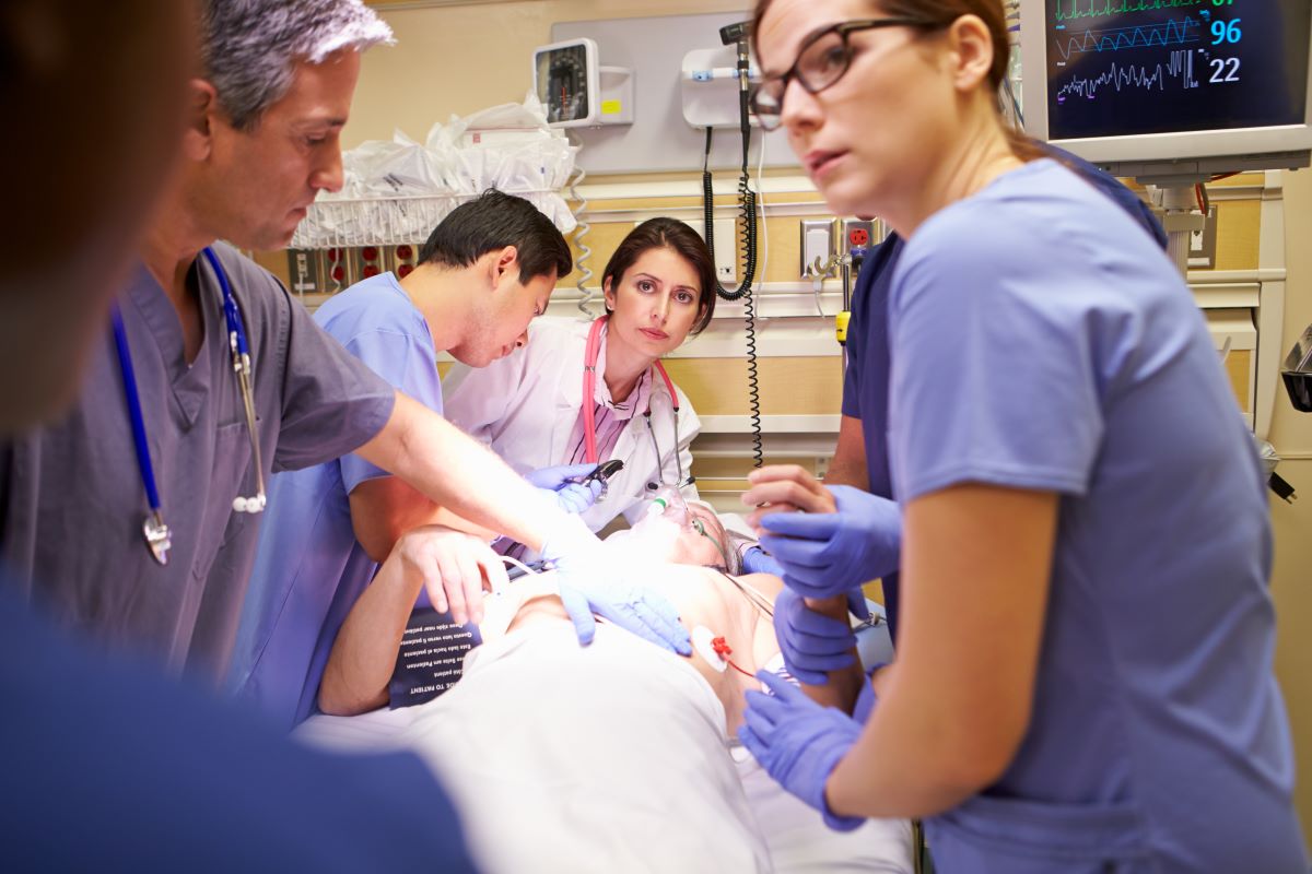 ER nurses and physicians help a patient who needs urgent assistance.
