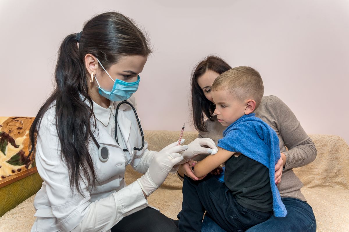A family nurse practitioner gives a child a vaccination.