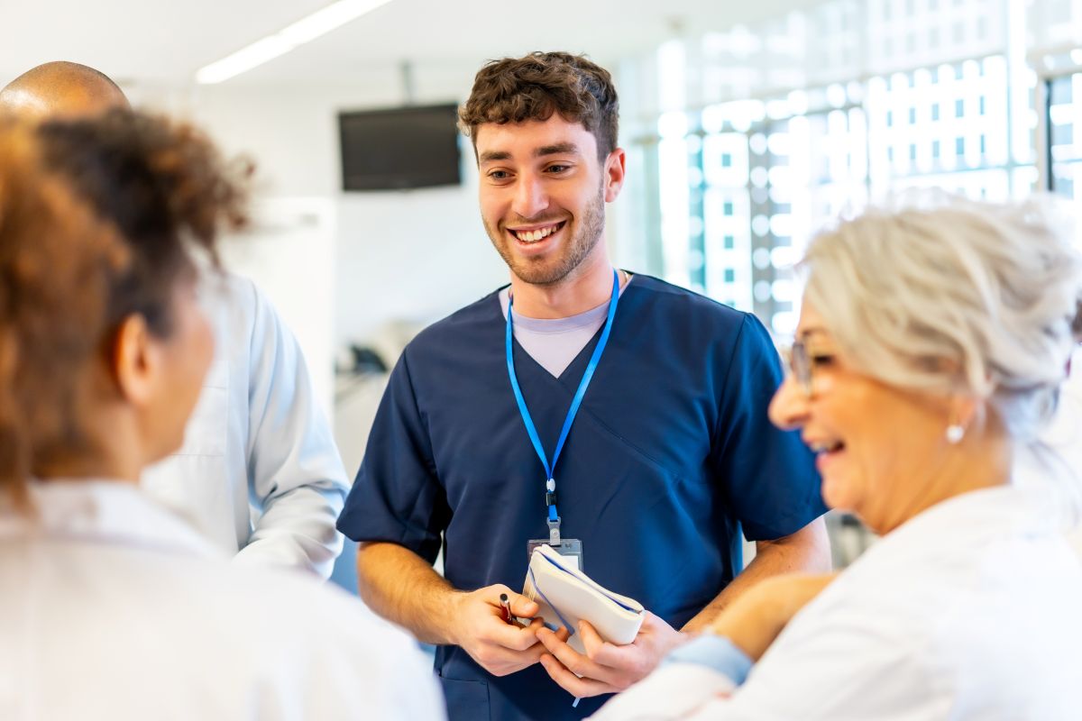 A nurse talks with his colleagues.