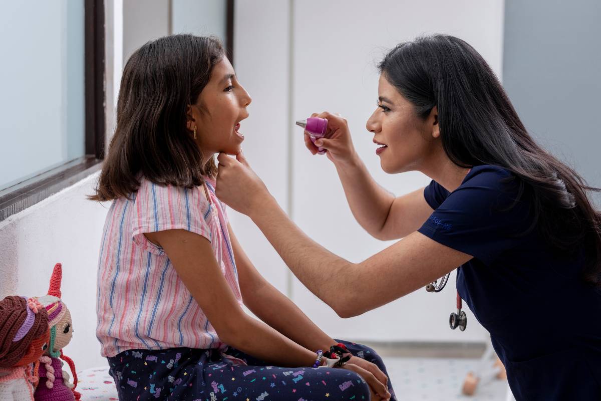 A healthcare professional conducts a head-to-toe assessment, nursing focused.
