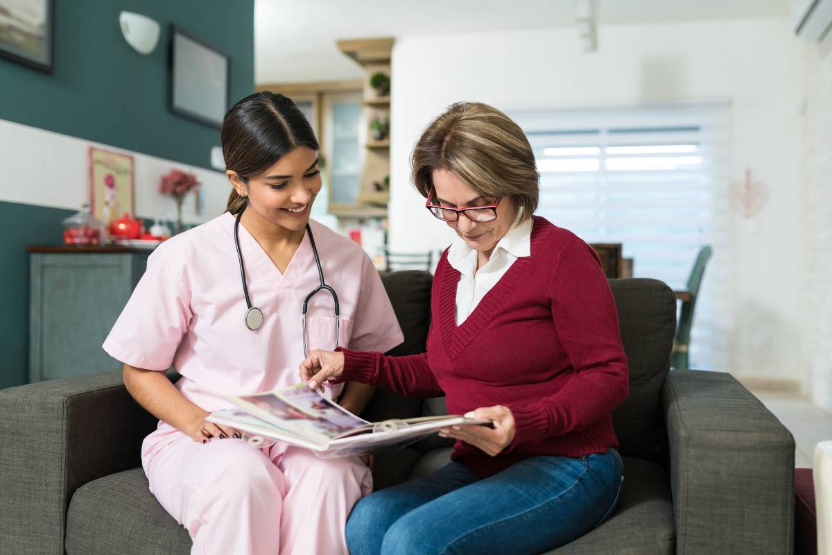 A nurse with holistic nursing certification meets with a patient in their home.