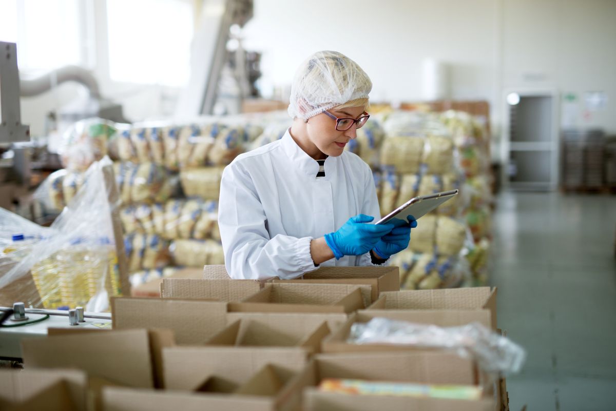 A hospital logistics worker checks to make sure a shipment matches the order.
