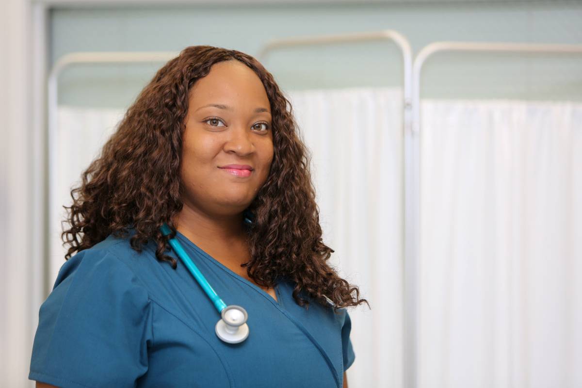 A nurse poses for a photo while discusses how to become an RN in Mississippi.