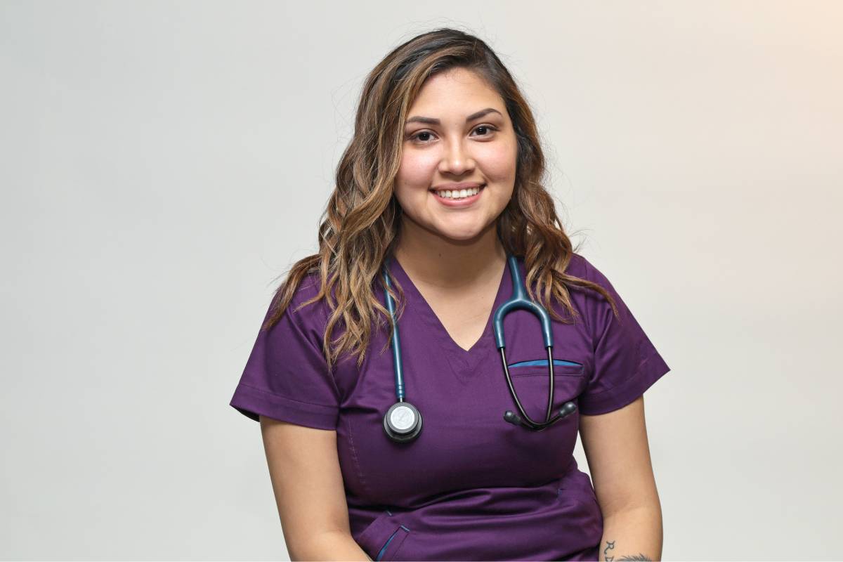 A nursing professional poses for a photo while discussing how to become an RN in Nevada.