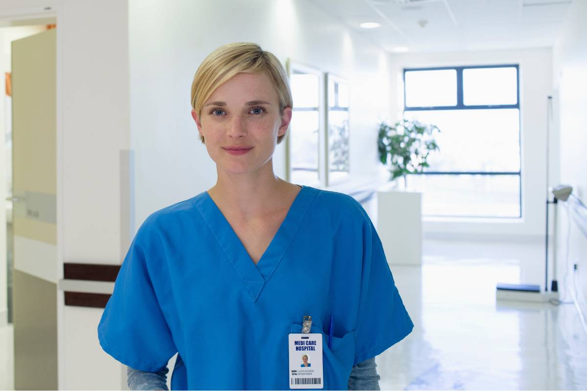 A nurse poses for a photo while discussing how to become an RN in New Hampshire.