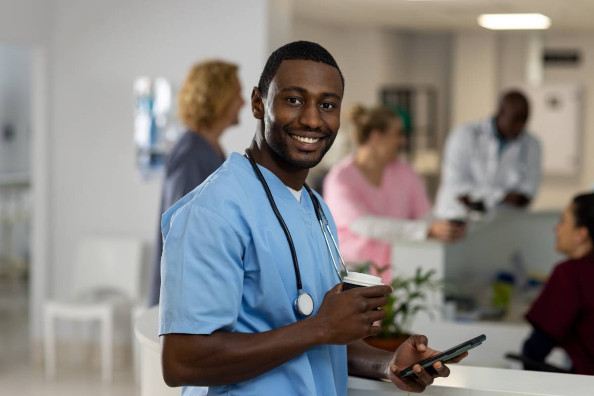 A nurse poses for a photo in a clinic lobby while discussing how to become an RN in South Carolina.