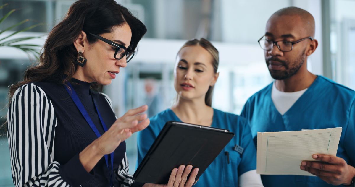 Two nurses discuss their key performance indicators with the HR manager.