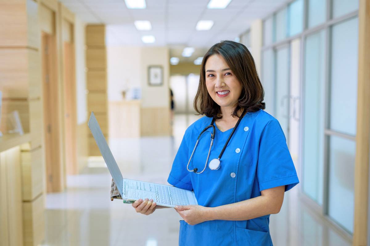 A nurse poses for a photo while discussing the process of going from an LVN to RN career.