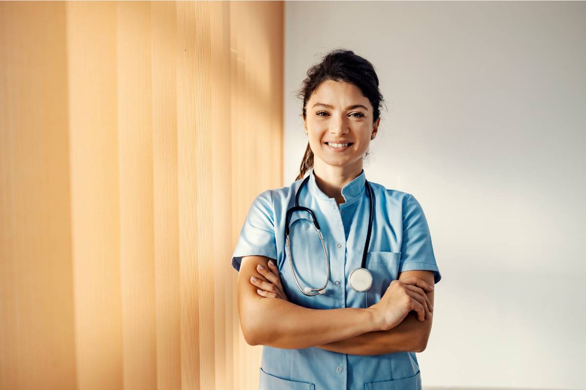 A nurse poses for a photo while discussing the difference between LVN vs. RN roles.