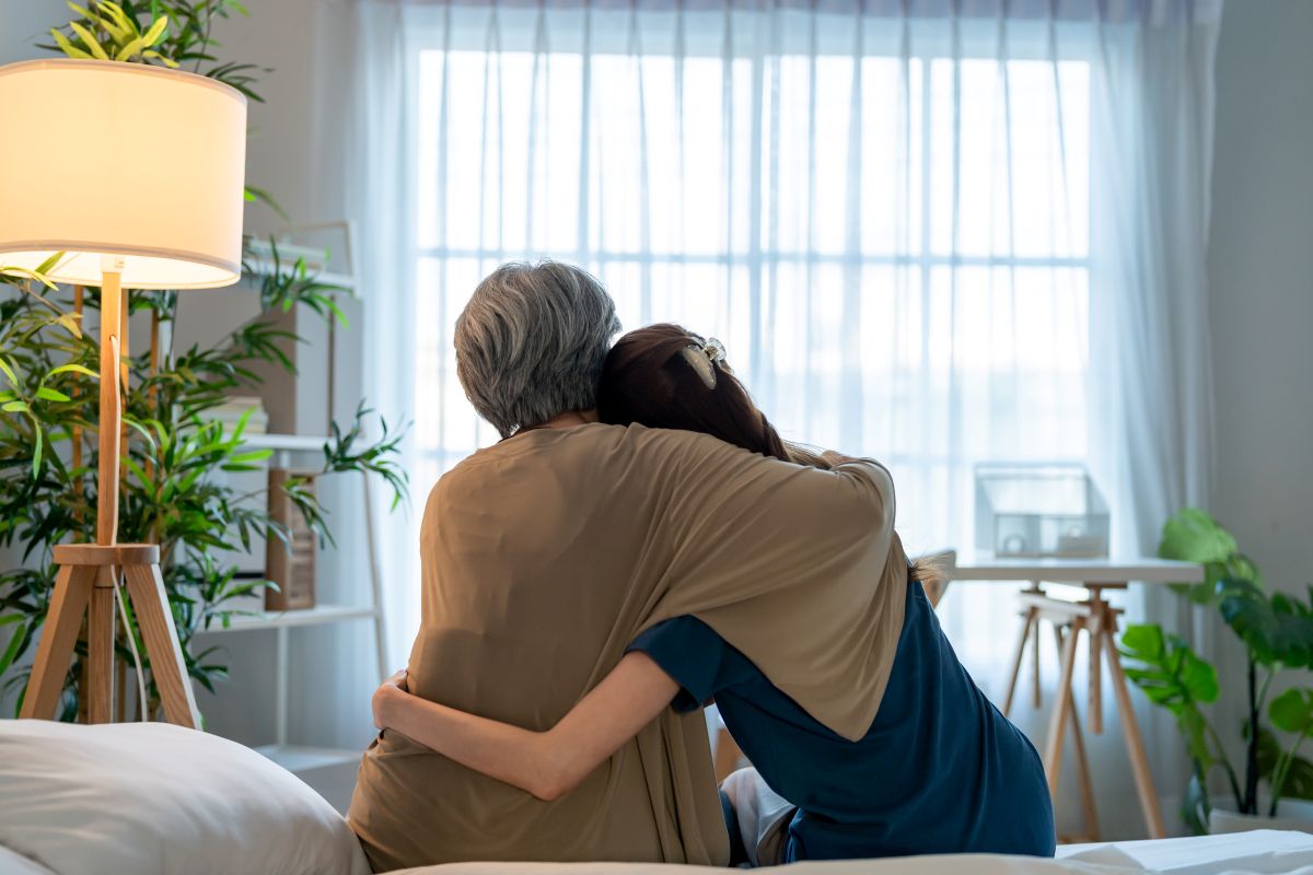 A nurse embraces one of her patients, who is receiving comfort care.