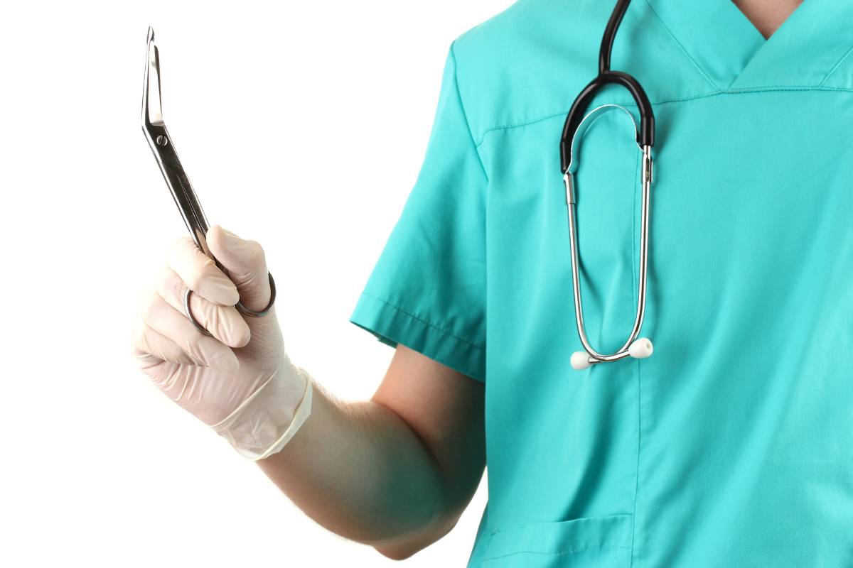 A nurse displays their medical scissors.