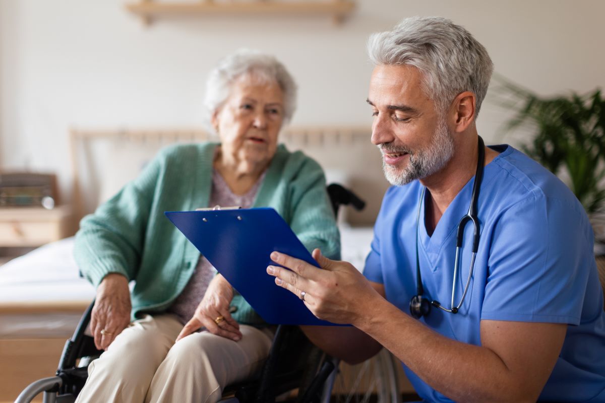 A nurse at a skilled nursing facility looks at a patient's chart.