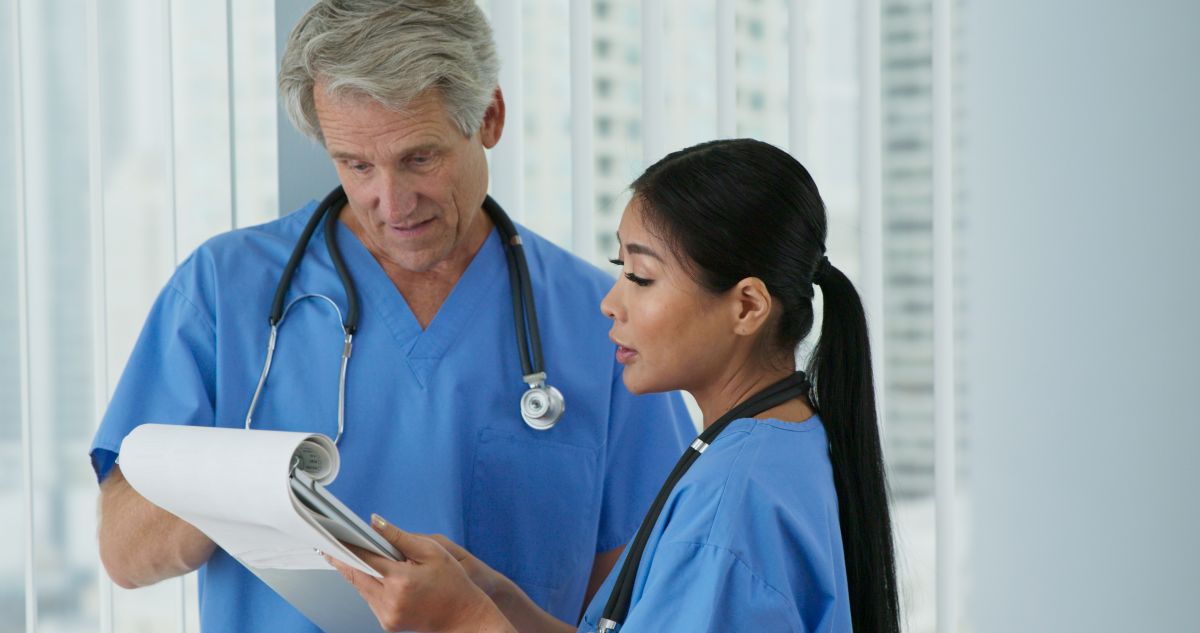 Two Nebraska nurses look at a chart together.