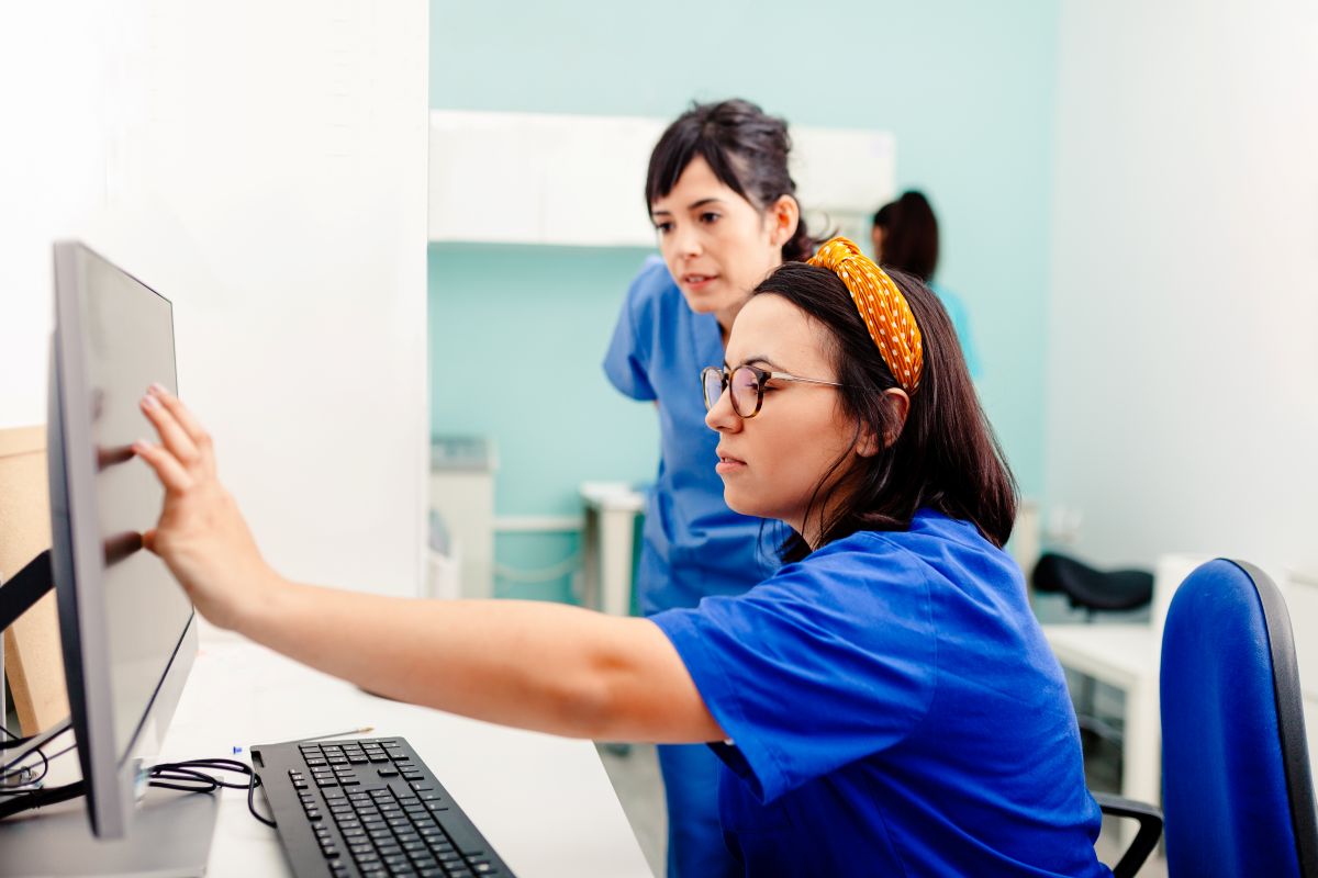 Two nurses use NLP software to ease their administrative workload.